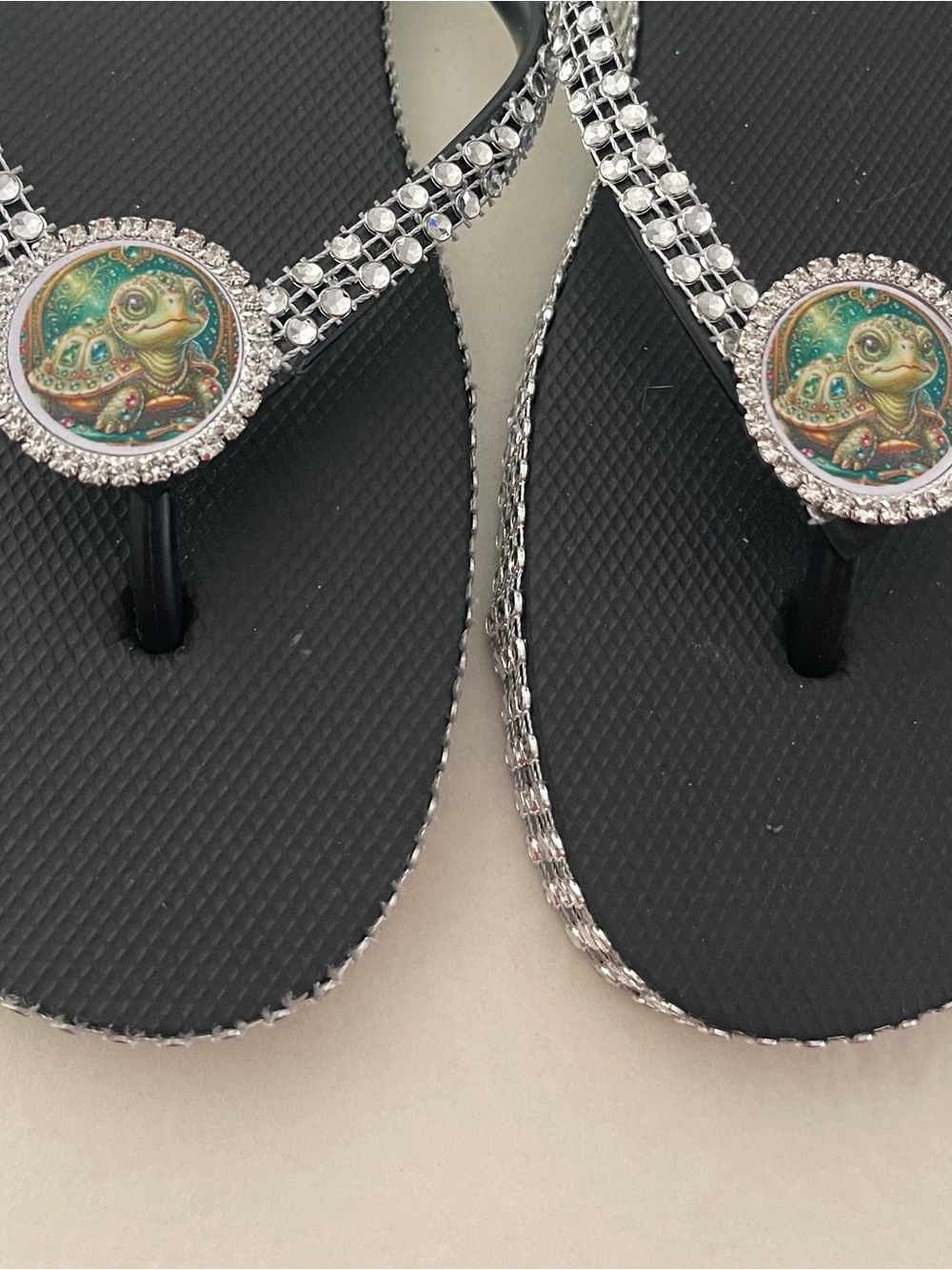 Black Crystal-Trim Flip Flop Sandals with Turtle Medallion